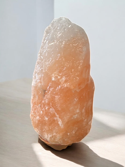 Orangene Salzlampe aus Himalaya Salz vor weißem Hintergrund